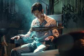 A man tied to a chair in the Netflix K-drama Gyeongseong Creature.