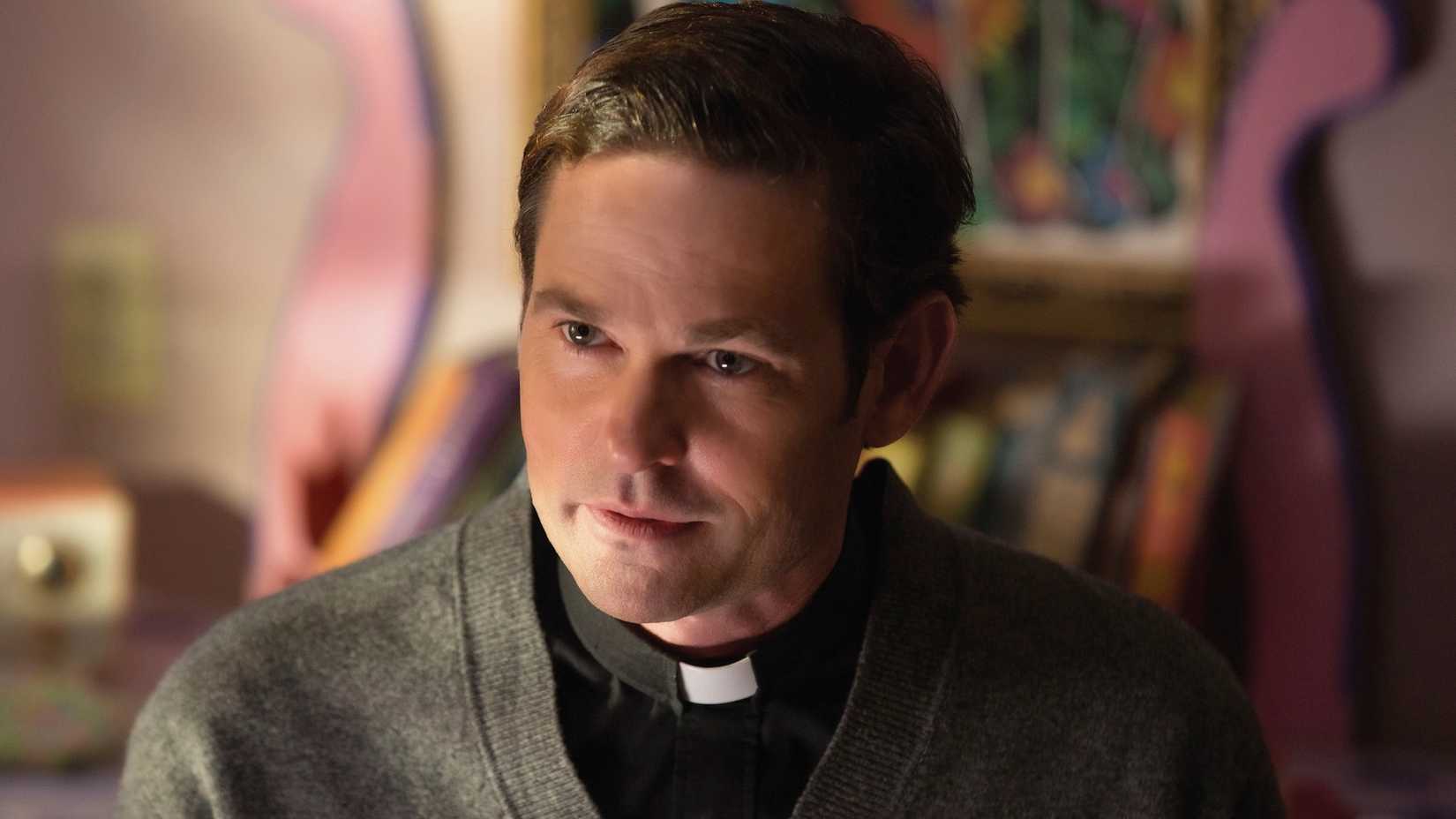 Henry Thomas as a priest talking to someone in Ouija Origin of Evil