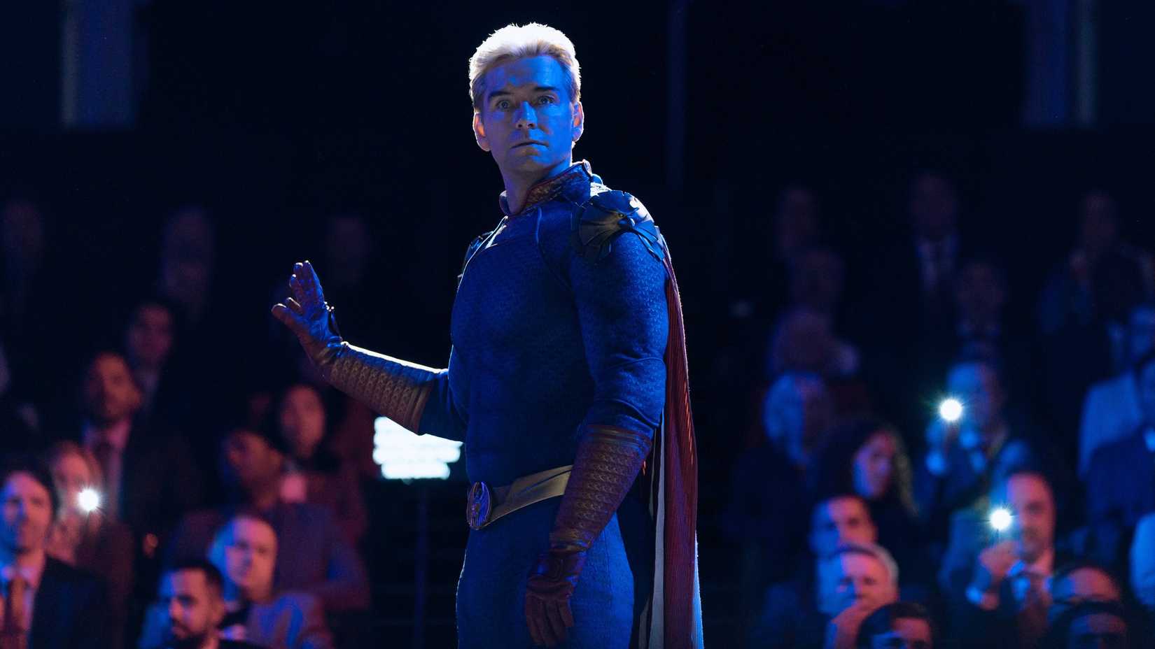 homelander standing in front of a crowd with his hand out looking surprised in the boys season 5