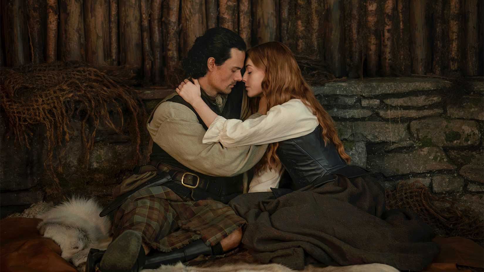 Jamie Roy as Brian Fraser embracing Harriet Slater as Ellen MacKenzie in Outlander Blood of My Blood season 2-2