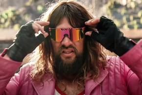 Jason Momoa putting on wraparound sunglasses in A Minecraft Movie