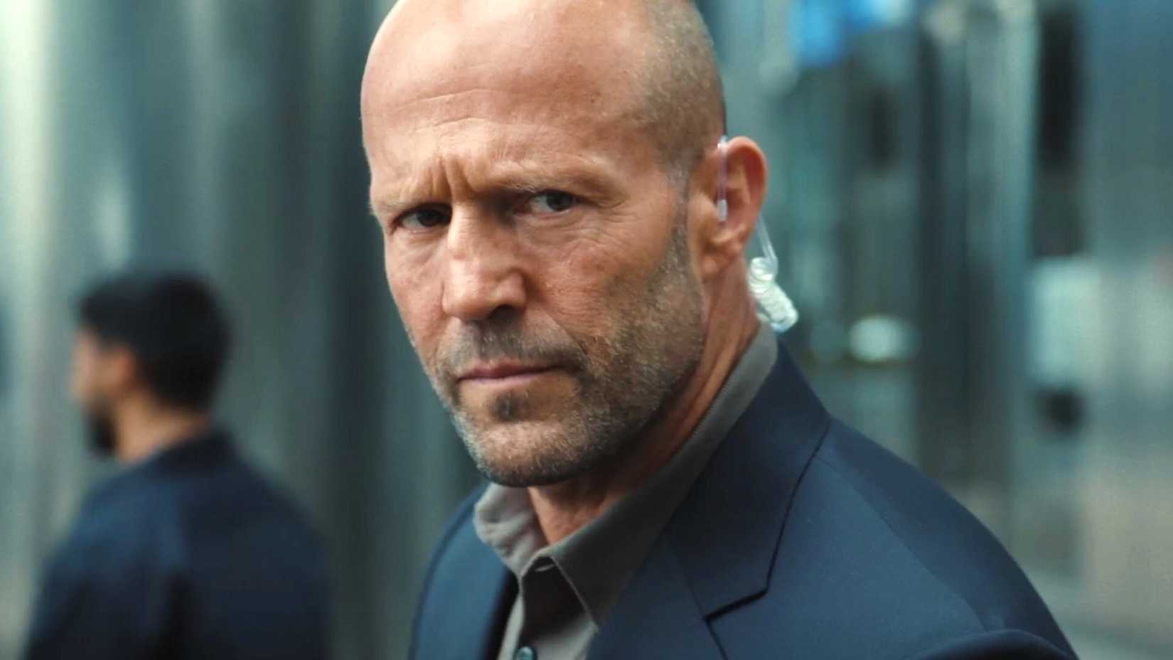 Jason Statham is an agent listening to something in Mutiny