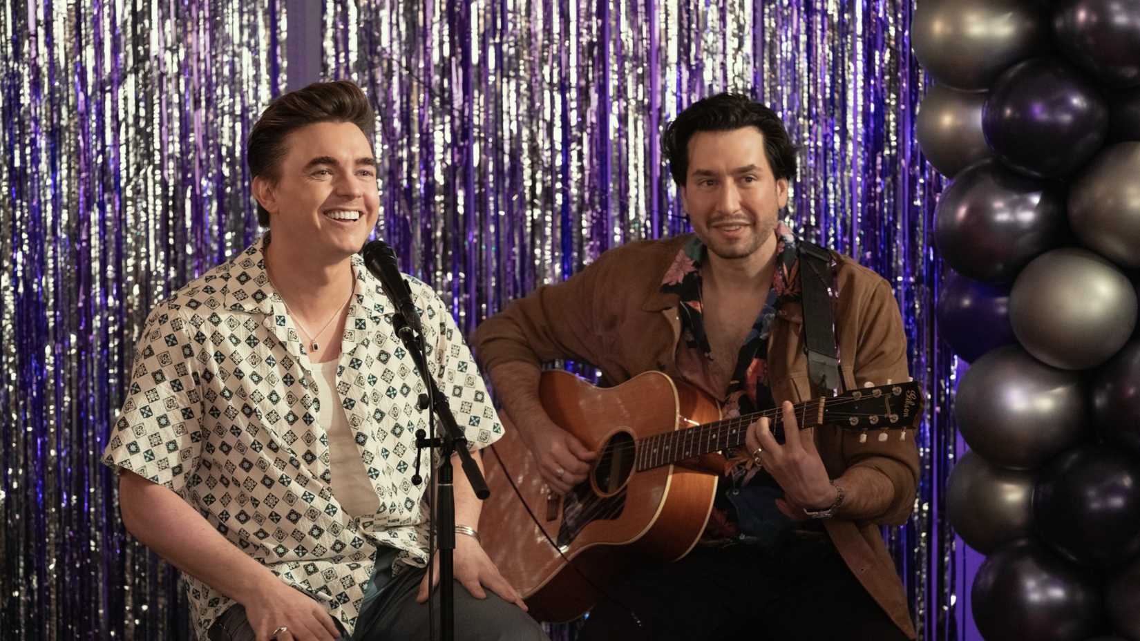 Jesse McCartney and a man with a guitar performing in Hacks season 5, episode 2