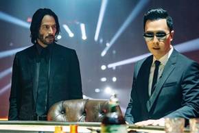 John Wick and Caine stand next to each other in John Wick