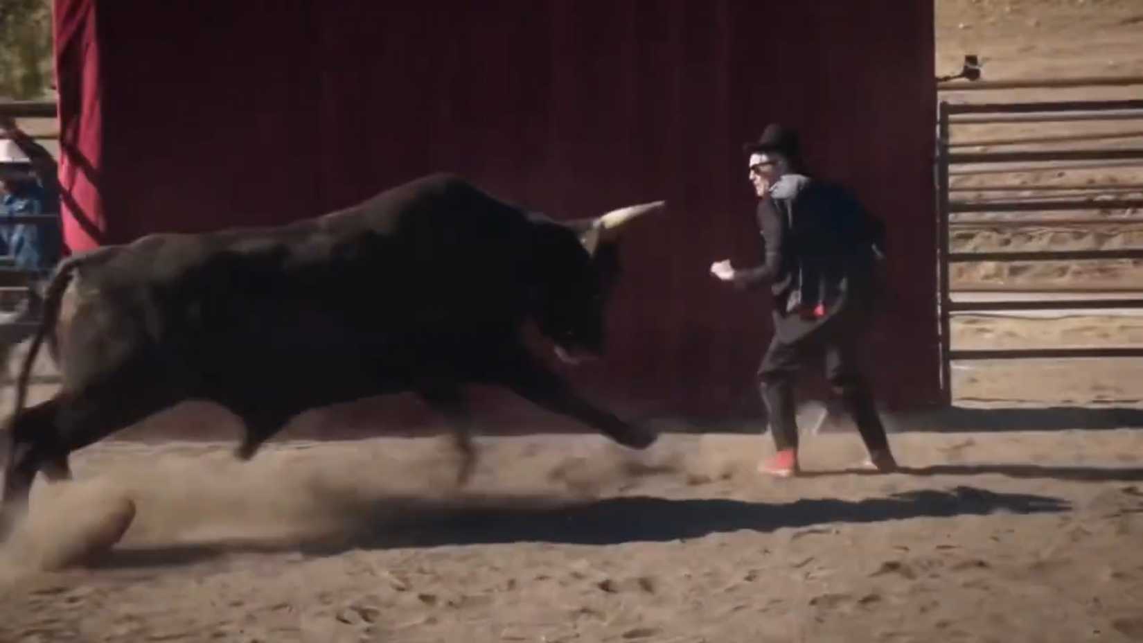 Johnny Knoxville about to get hit by a charging bull during the magic trick in Jackass Forever