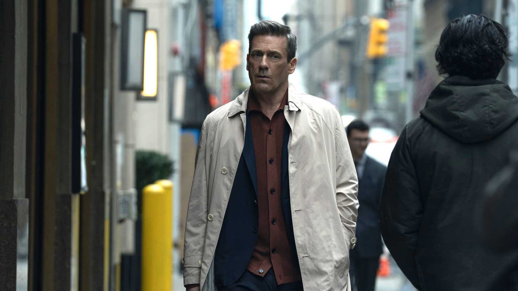 jon hamm s coop looking in thought while walking down the street in your friends neighbors season 2