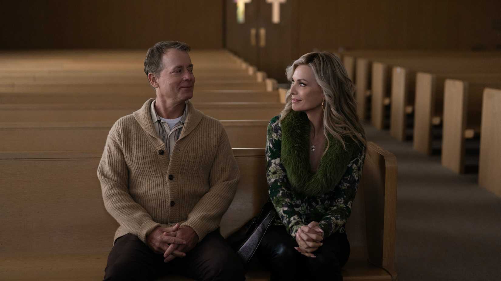 Kenny (Greg Kinnear) and Shyanne (Michelle Pfieffer) sitting in a church pew in Margo's Got Money Troubles