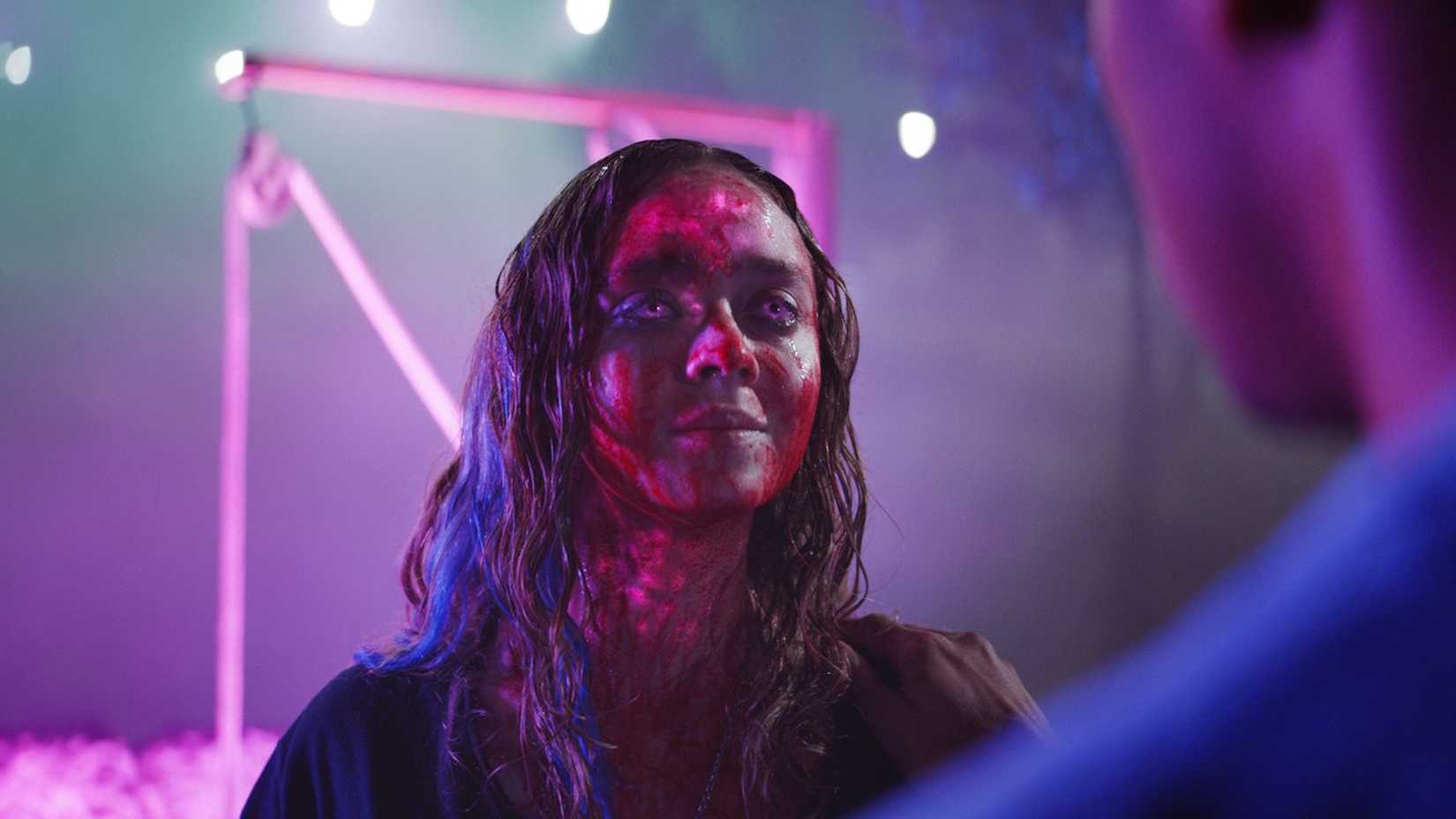 Lavinia blankly staring covered in blood in colors out of space