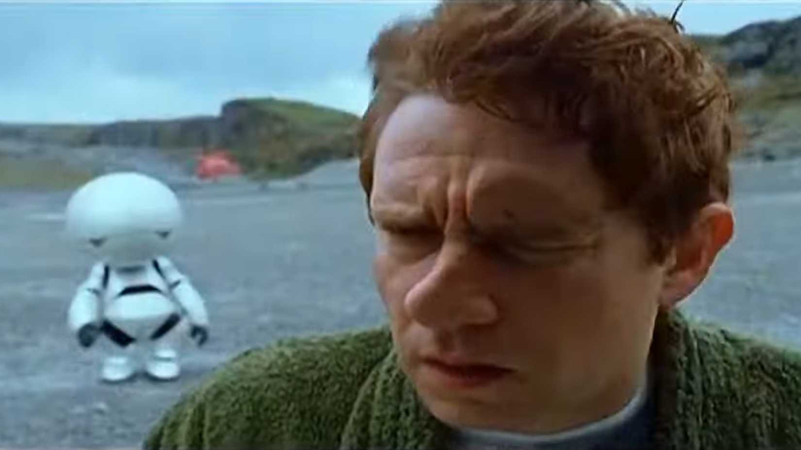 martin freeman arthur dent with marvin the android in the background in hitchhikers guide to the galaxy