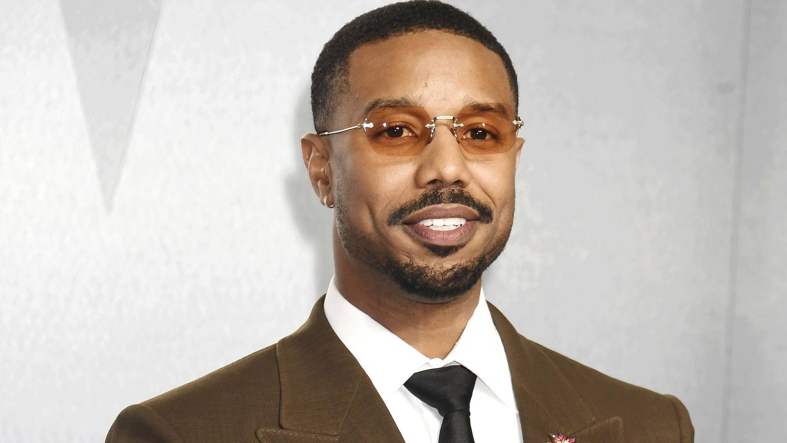 Michael B. Jordan Engages In Flirtatious Cat & Mouse Chase In Stunning Trailer Of The Thomas Crown Affair Remake
