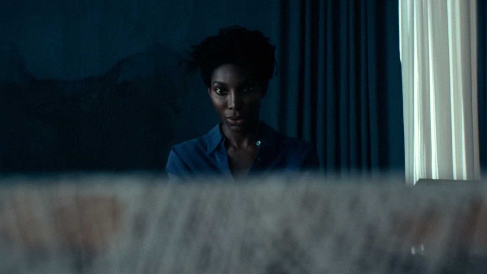 Michaela Cole As Sam Staring At A Piece Of Fabric In Mother Mary