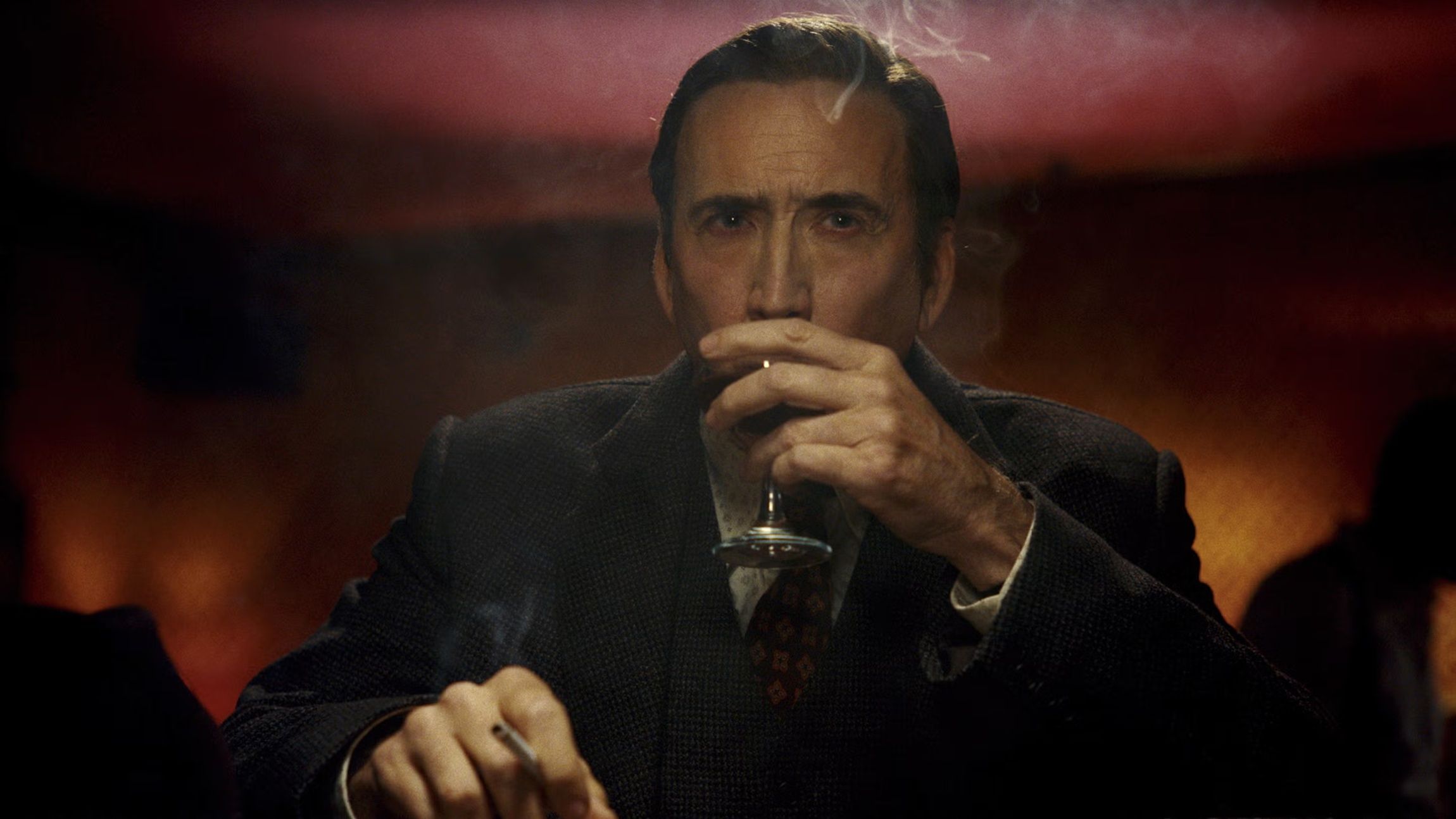 Nicolas Cage sipping a drink in Spider-Noir
