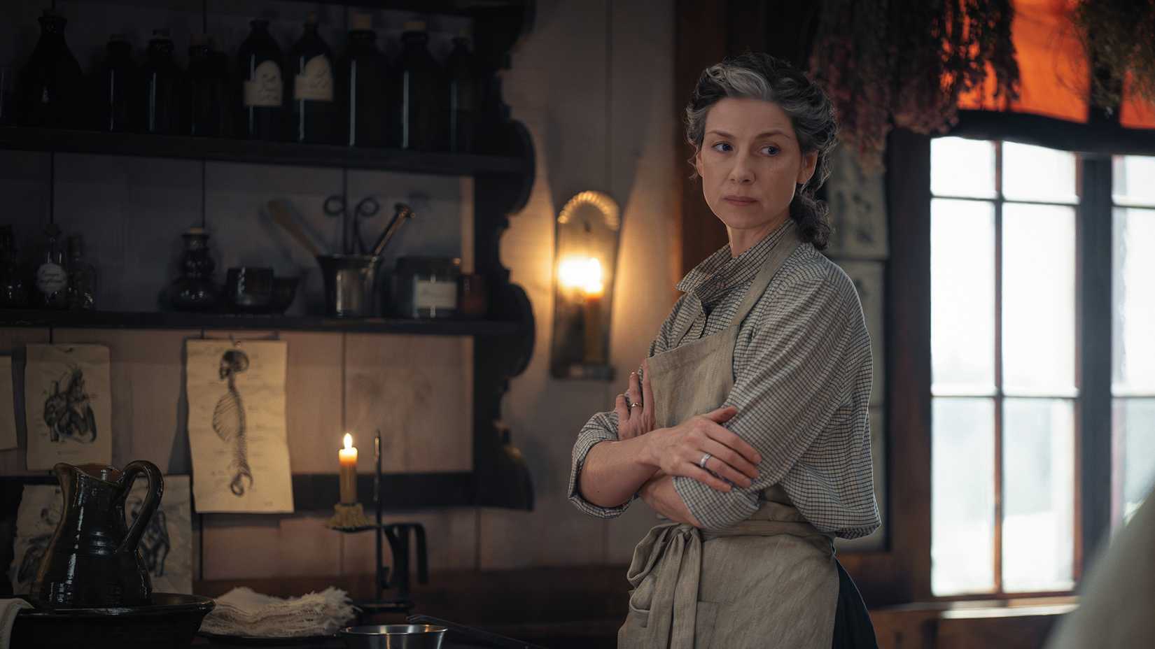 Claire stands in her surgery in season 8 of Outlander