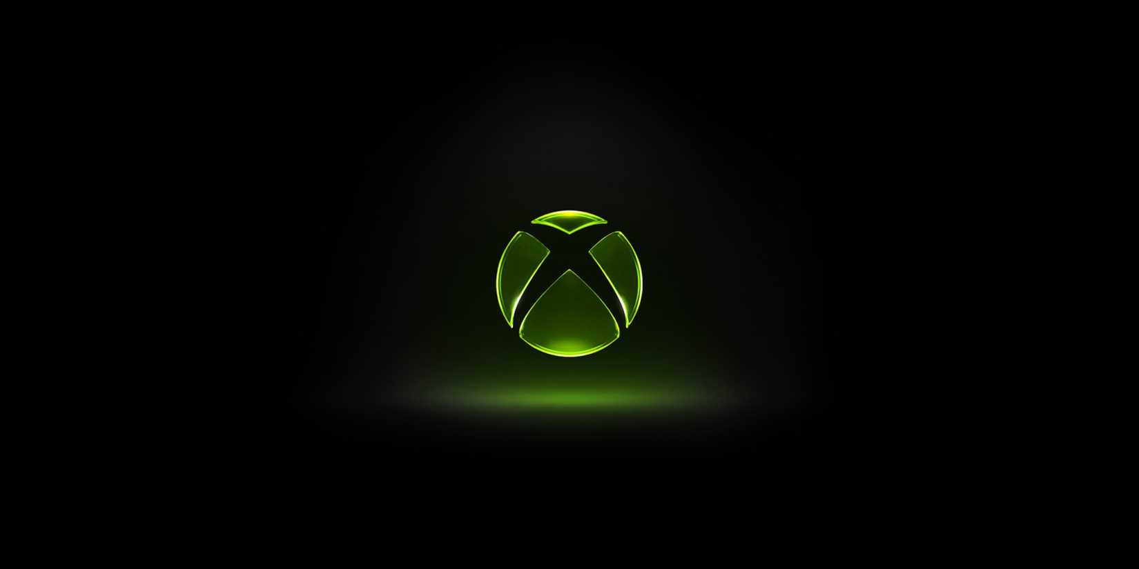 A logo for the original Xbox glows over a black background.