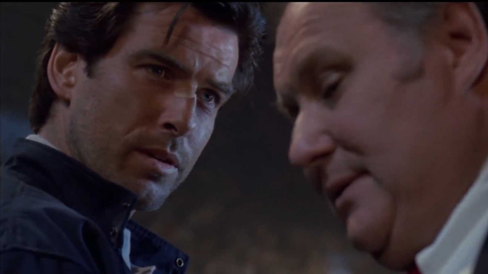 Pierce Brosnan looking serious talking to someone in Live Wire