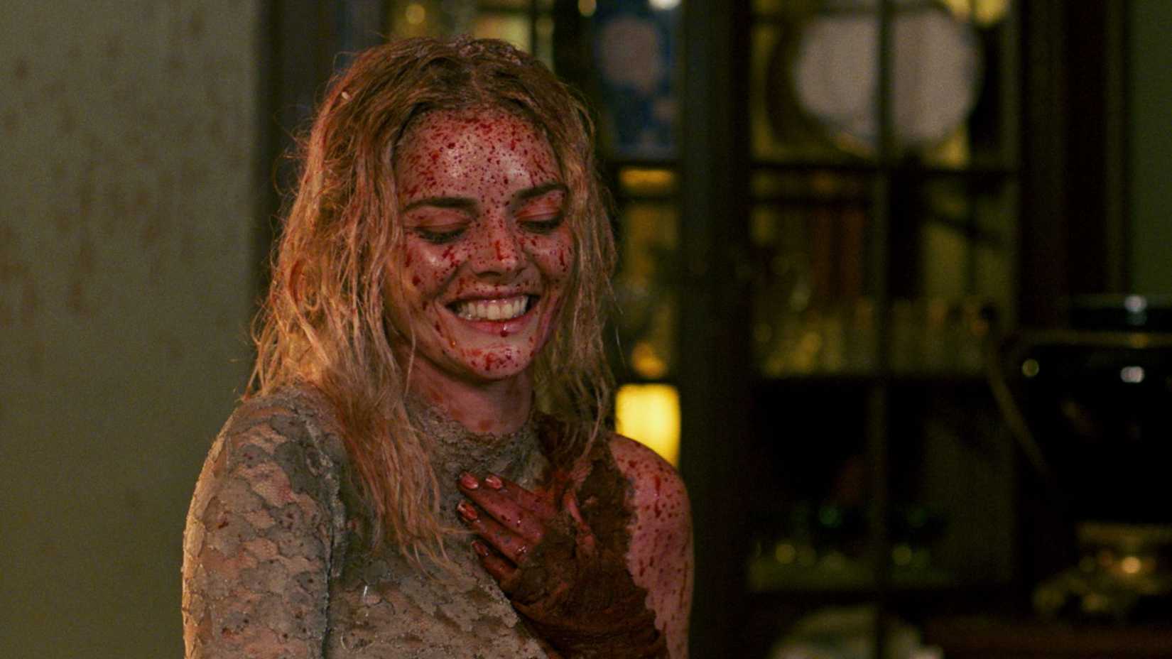 Samara Weaving covered in blood and laughing in Ready or Not