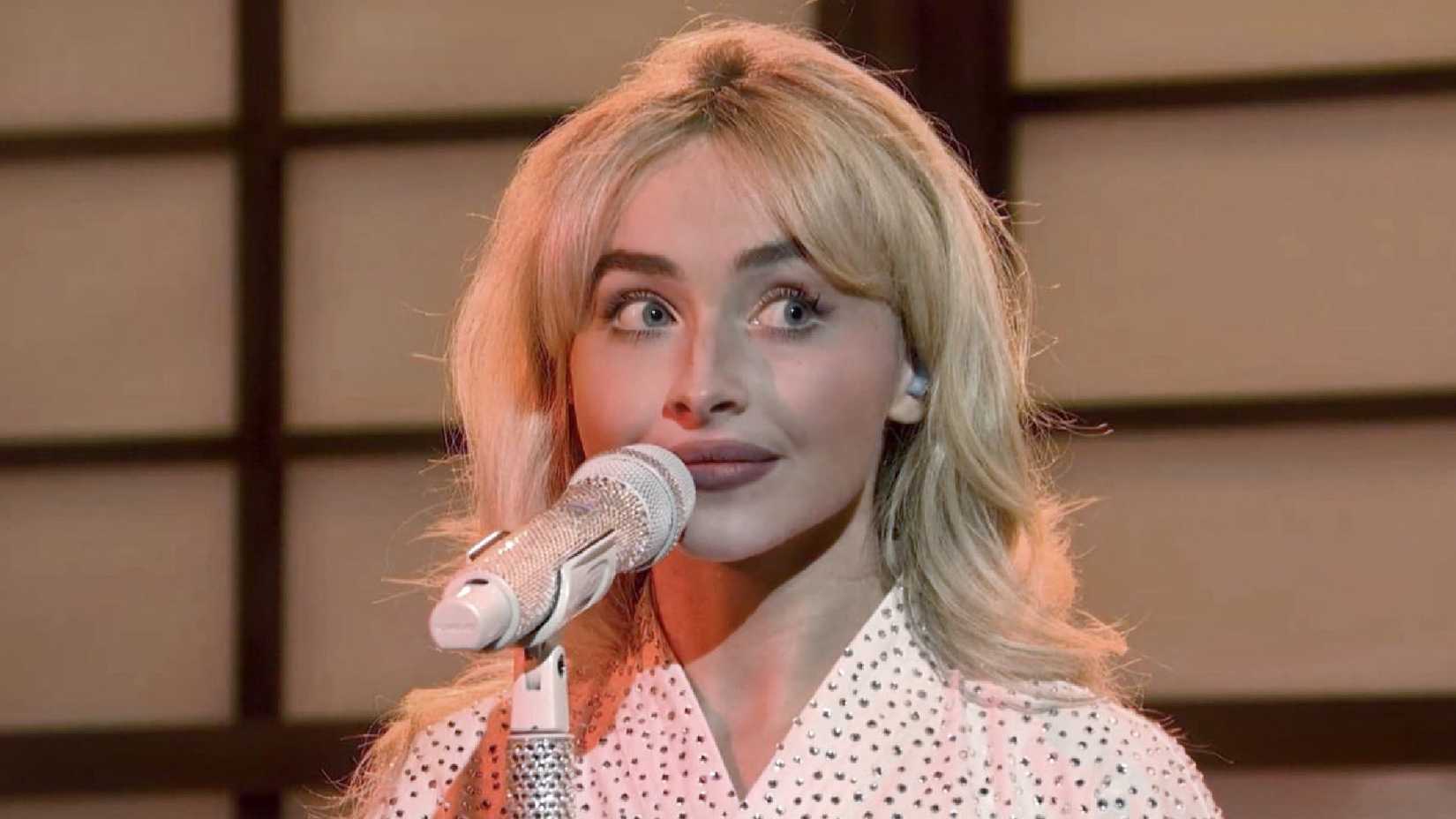 Sabrina Carpenter looks to the side while performing on SNL in 2025