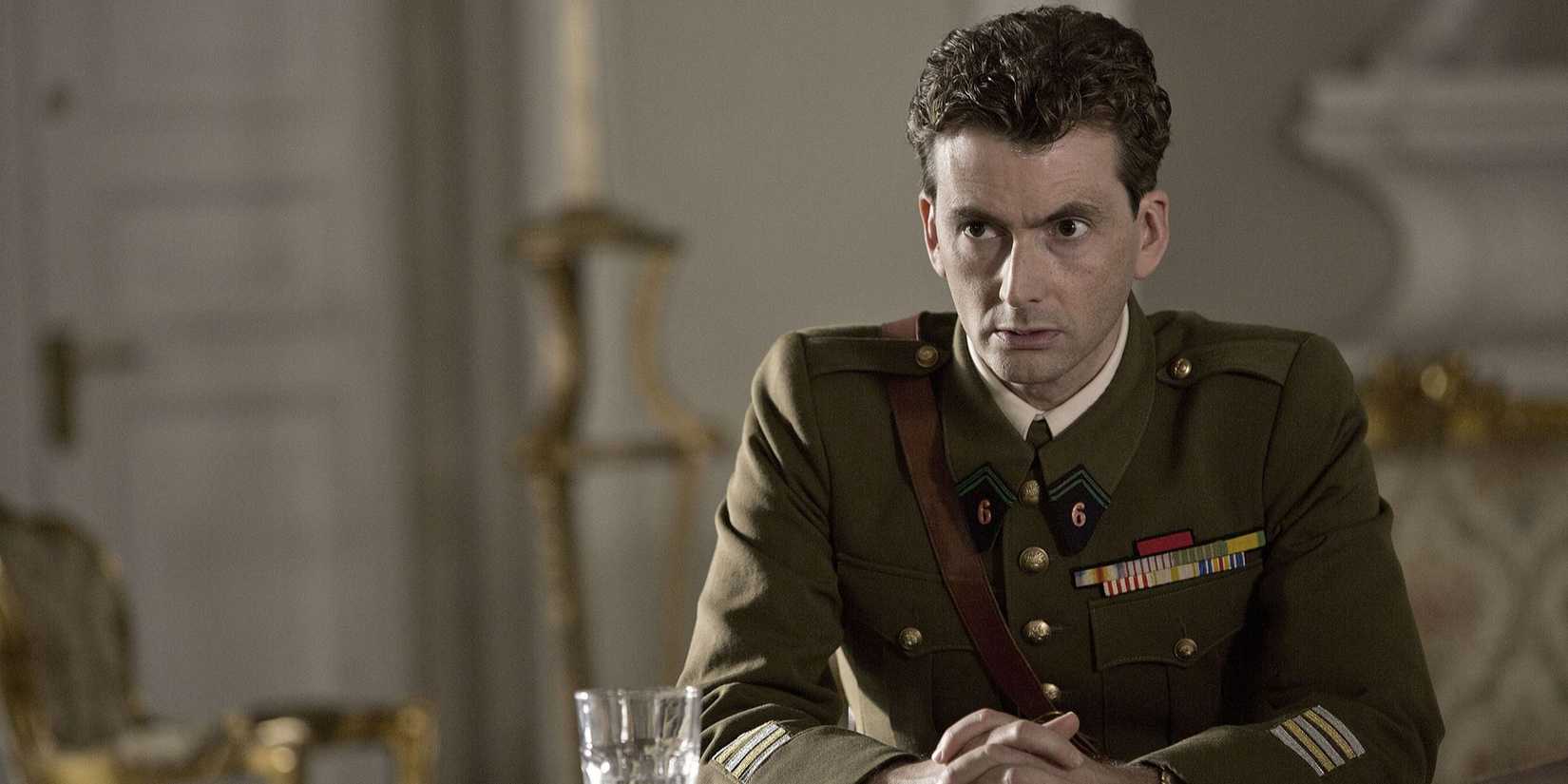 David Tennant vestindo um uniforme militar sentado em Spies of Warsaw