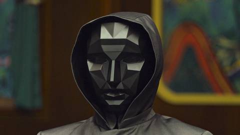 The Front Man in Squid Game wearing a geometric black mask.