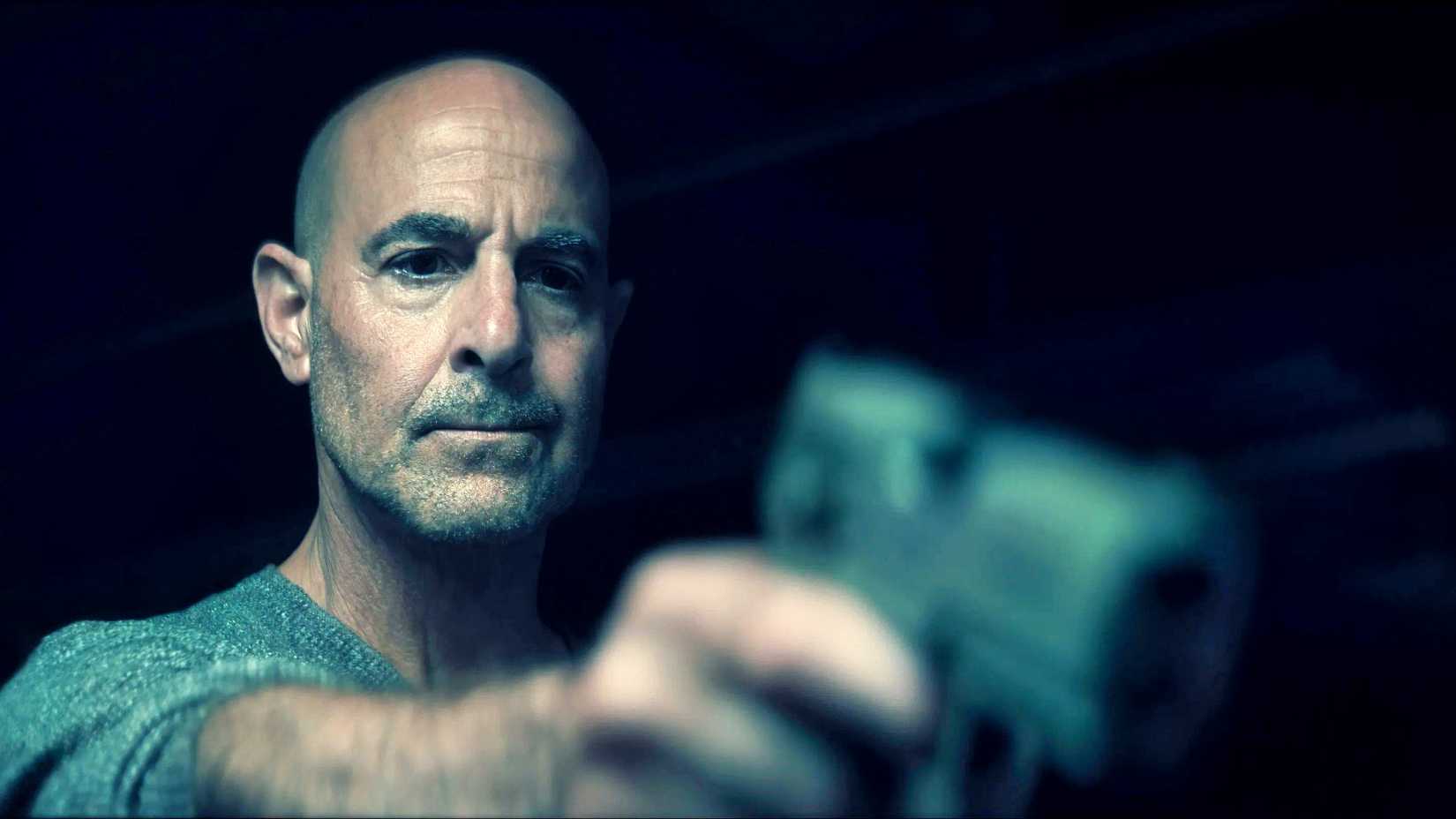 stanley tucci as bernard pointing a gun in citadel