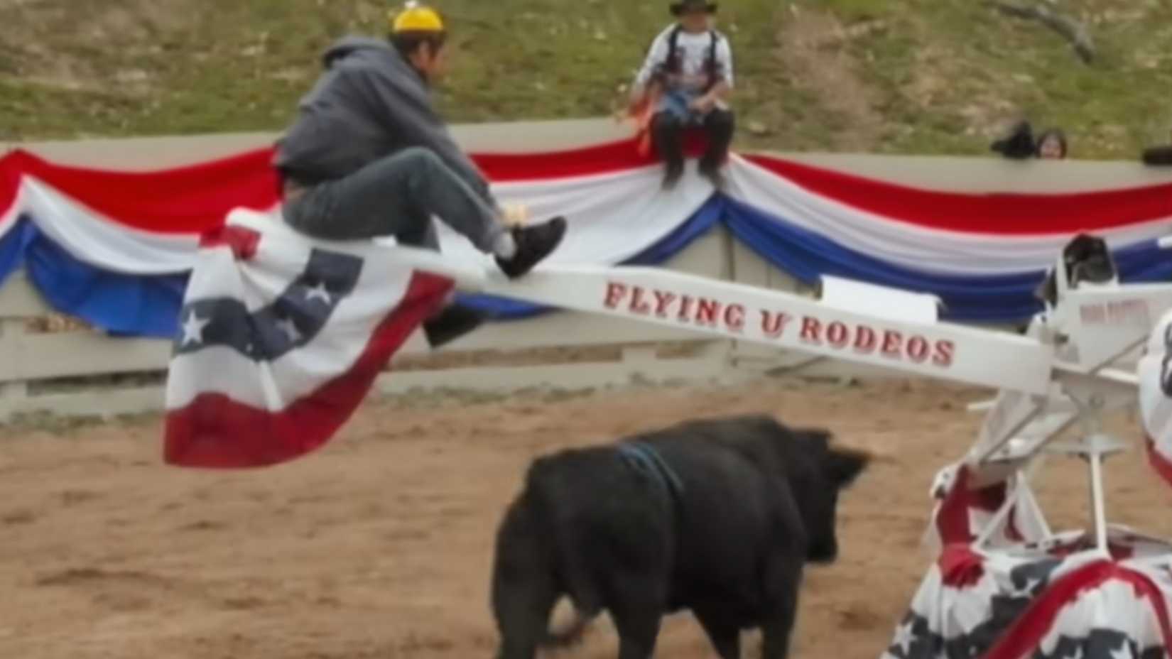 Steve O on a seesaw while an angry bull charges beneath him in Jackass Number Two