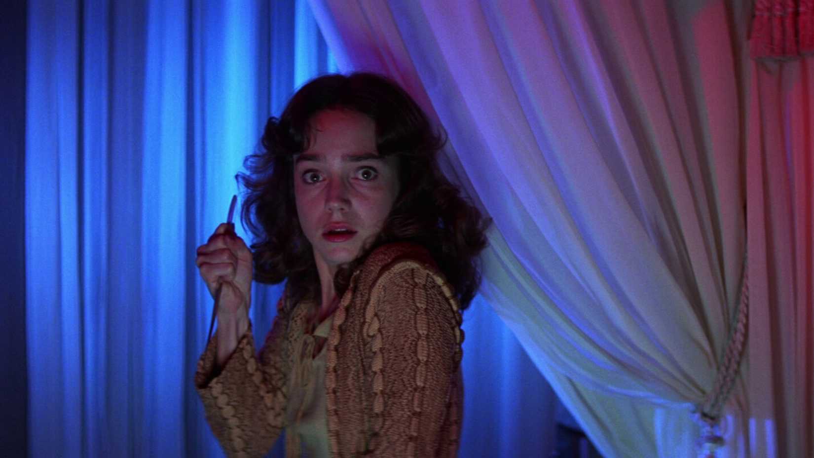 A woman holds a knife in Suspiria