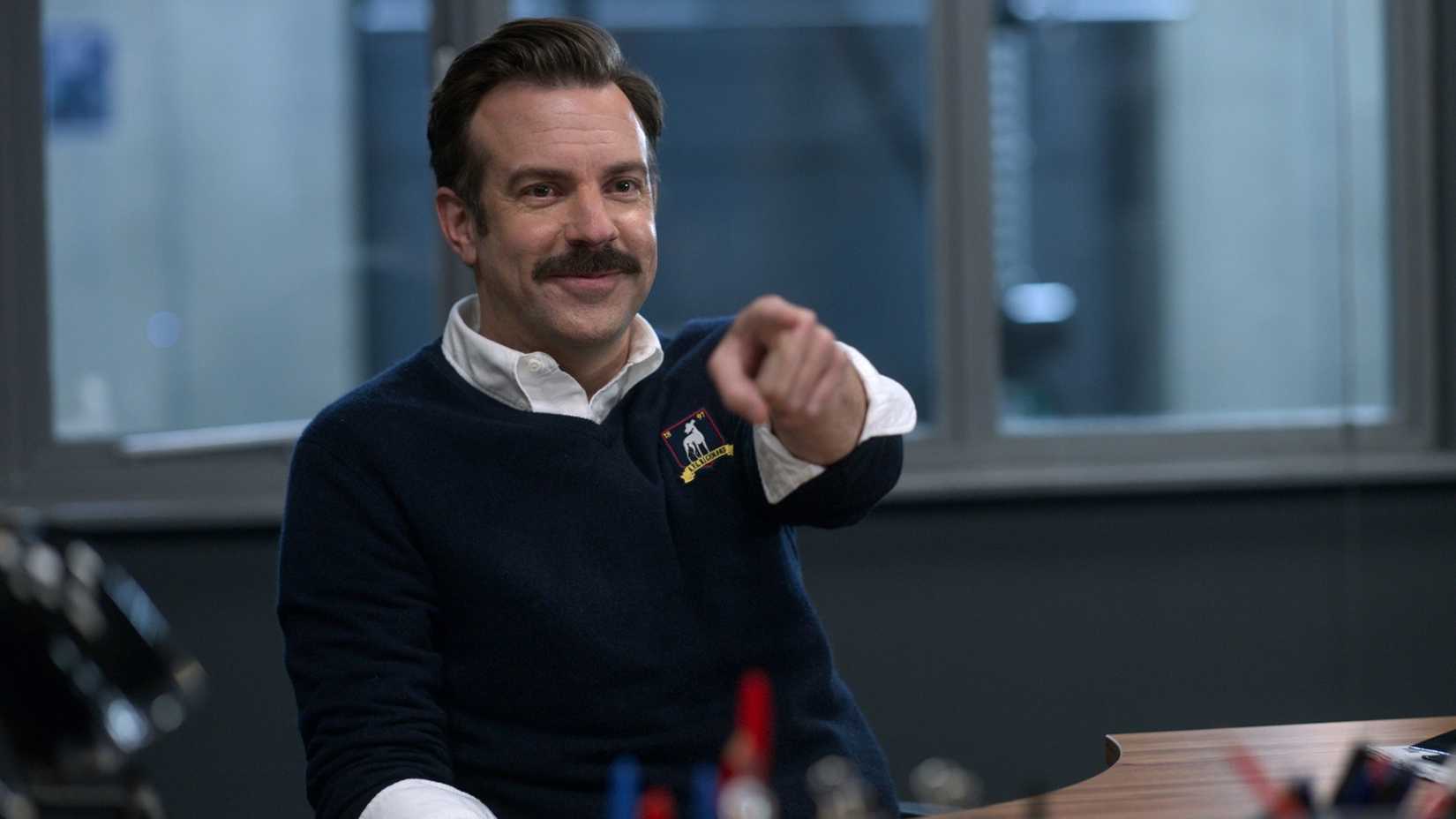 ted pointing a finger and smiling in ted lasso
