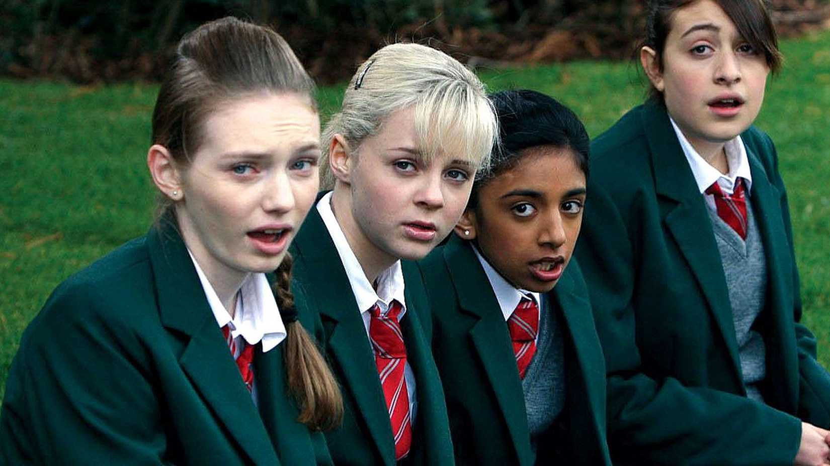 The girls sit in a row in school uniforms in Angus Thongs and Perfect Snogging