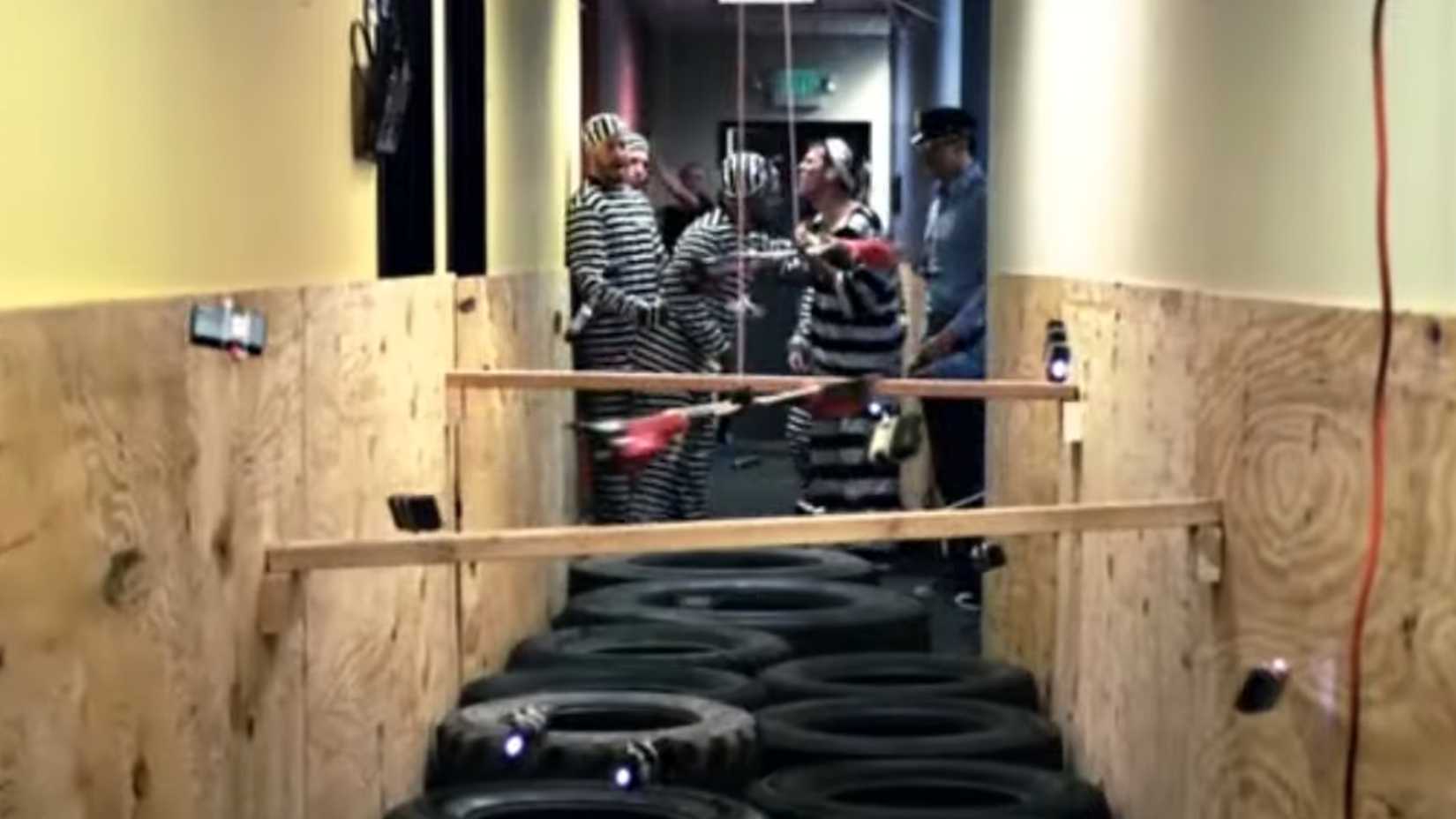 The Jackass crew dressed in black and white stripes ready to traverse the electric gauntlet in Jackass 3