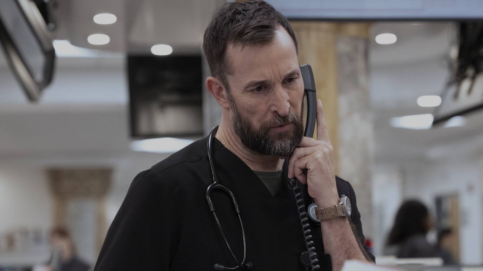 Dr. Robby (Noah Wyle) looking concerned while on the phone in The Pitt season 2, episode 13