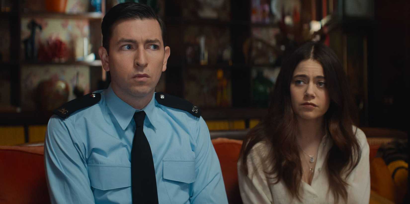 The police officer and the Shepard's daughter sit on a couch and look at in opposite directions in The Sheep Detectives