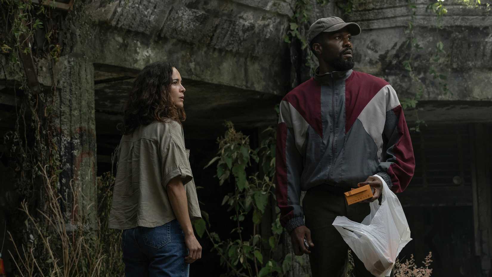 two people standing next to each other in man on fire