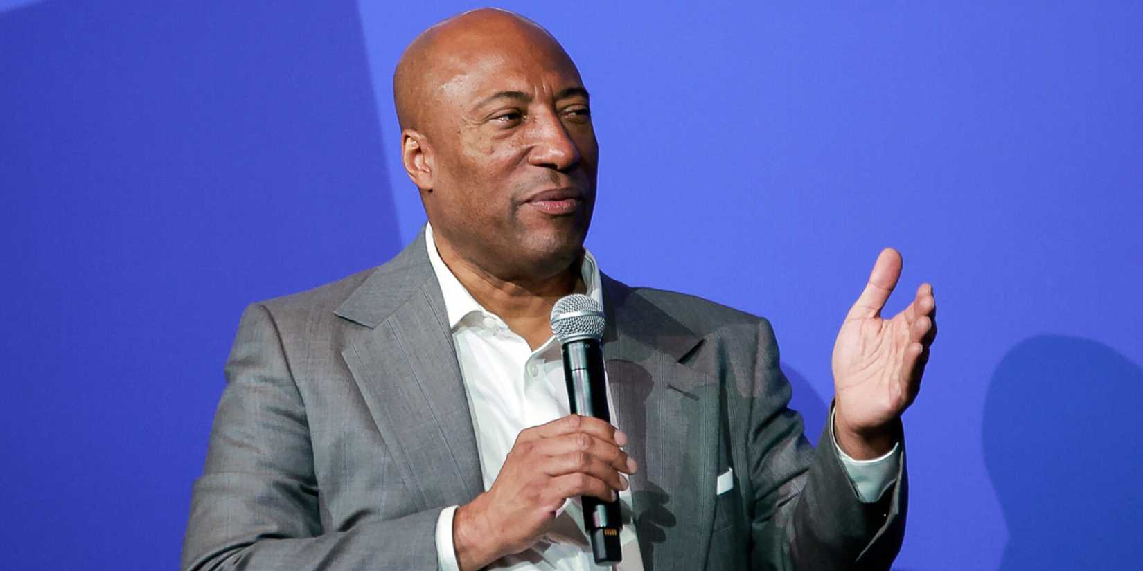 Byron Allen talking in to a microphone
