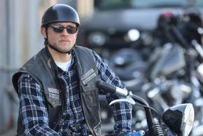 Jax on his bike wearing a helmet and sunglasses