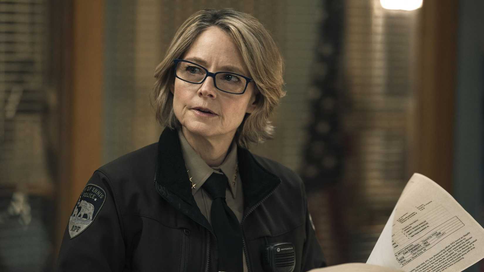 Jodie Foster holding a newspaper in True Detective 