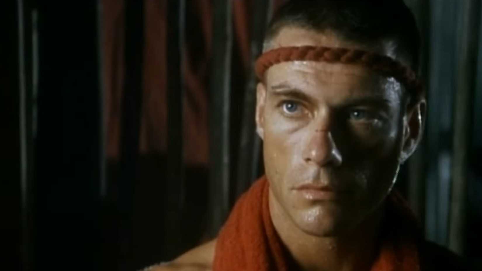 van damme wearing a red headband in The Quest