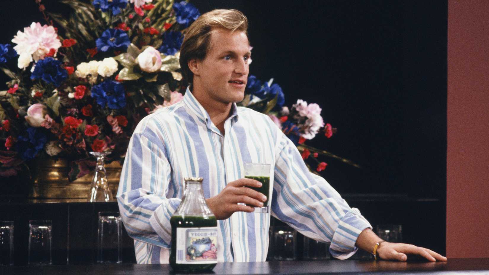 Woody holds a glass of Veggie Boy in the Cheers episode "Veggie-Boyd"