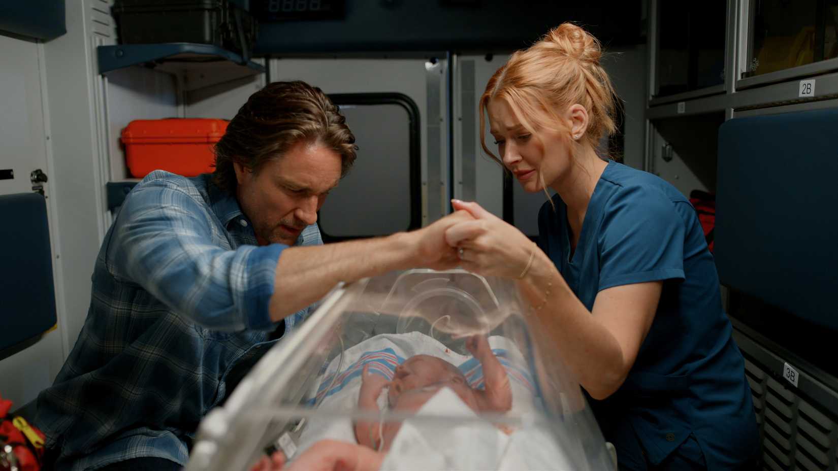 Jack and Mel hold hands over their baby while in the ambulance in Virgin River season 7 episode 10