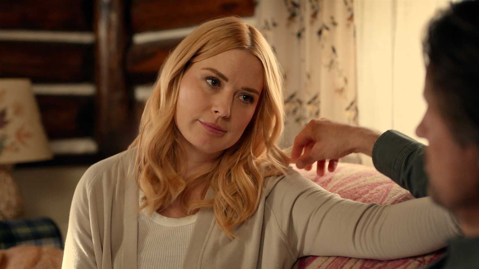 Mel sits on the couch and looks at Jack in Virgin River season 7 episode 1