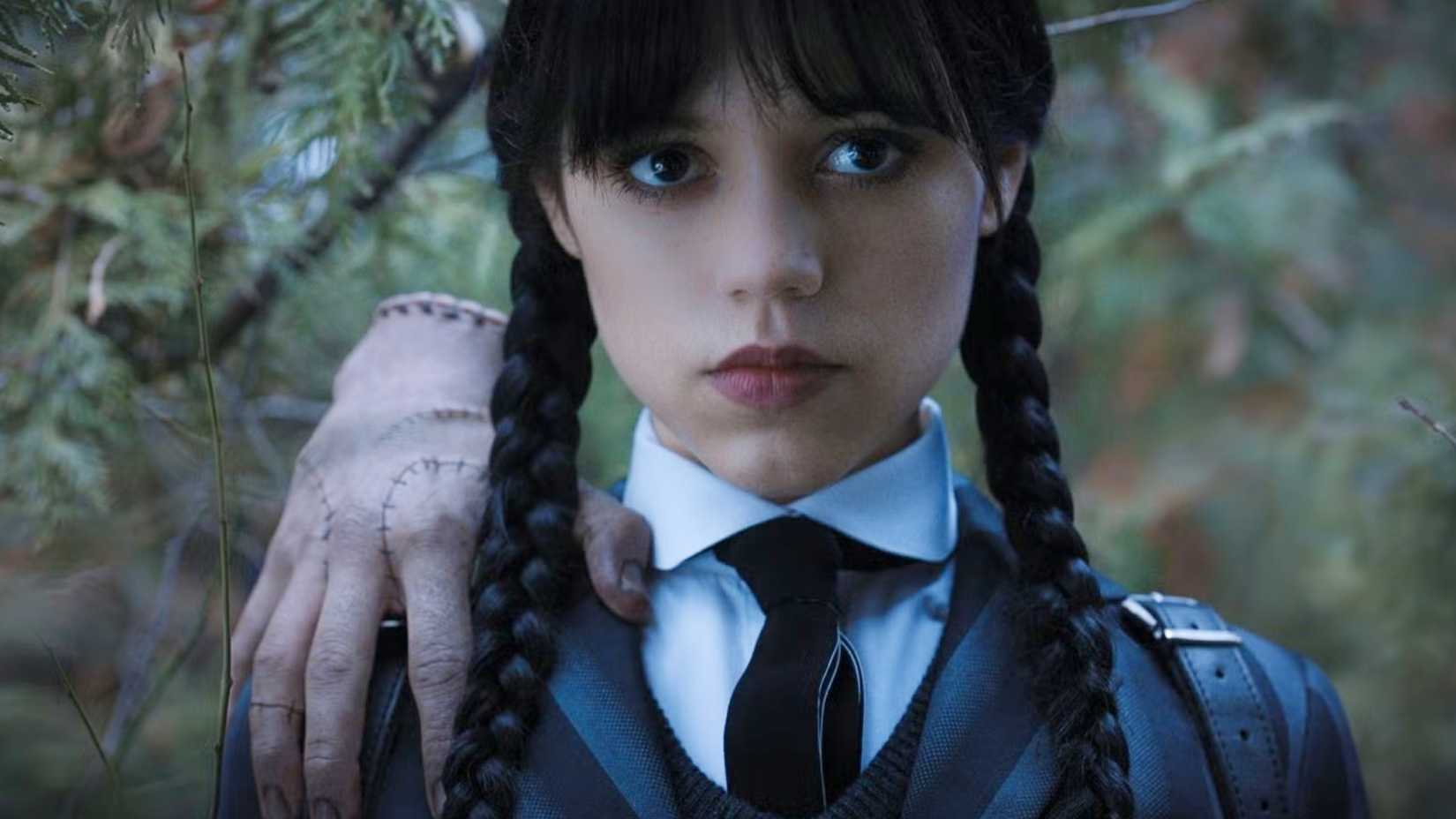 wednesday addams with thing on her shoulder