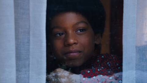 Young Michael Jackson looking out the window in Michael