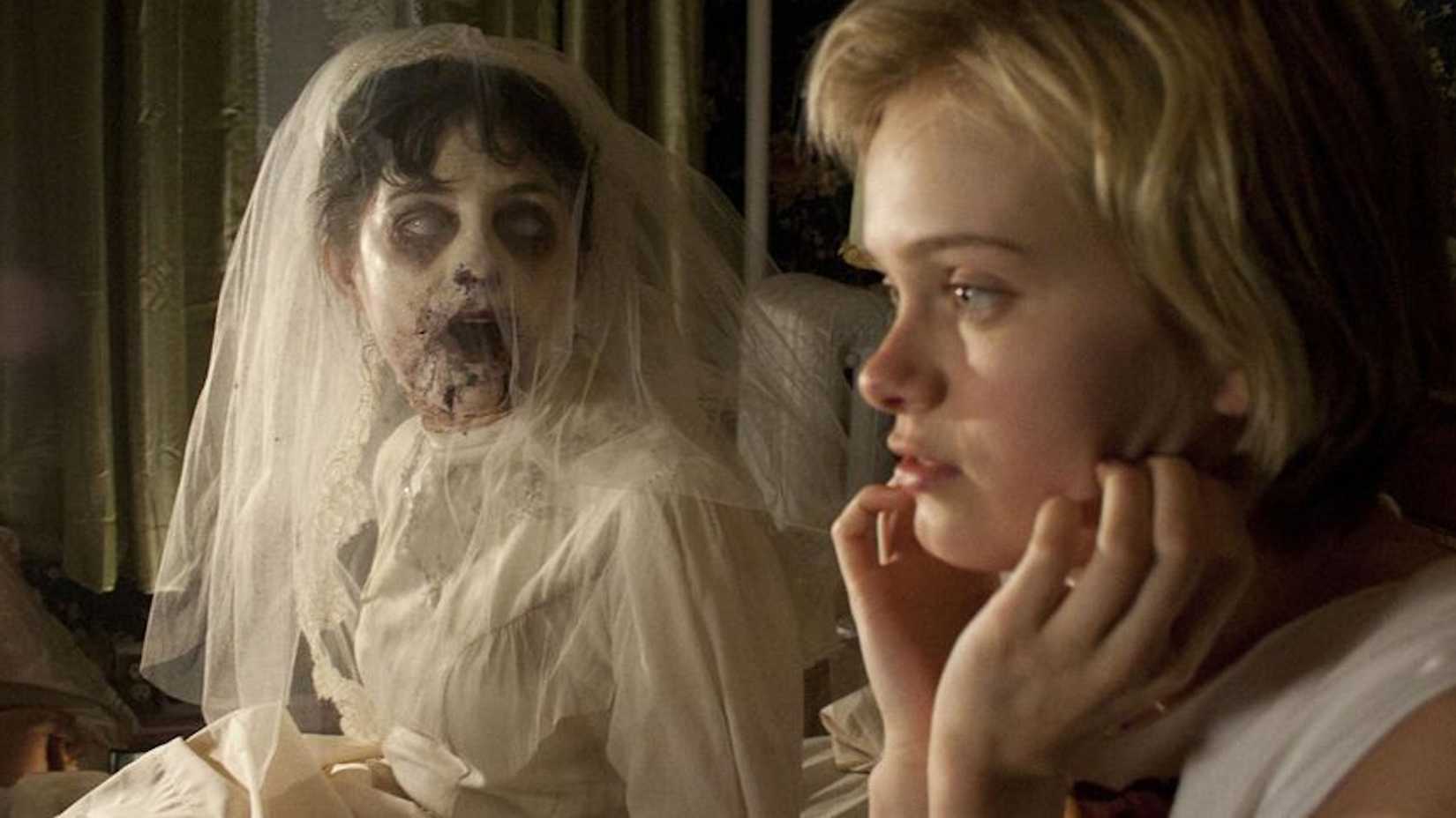 A terrifying ghost sits next to Claire in The Innkeepers