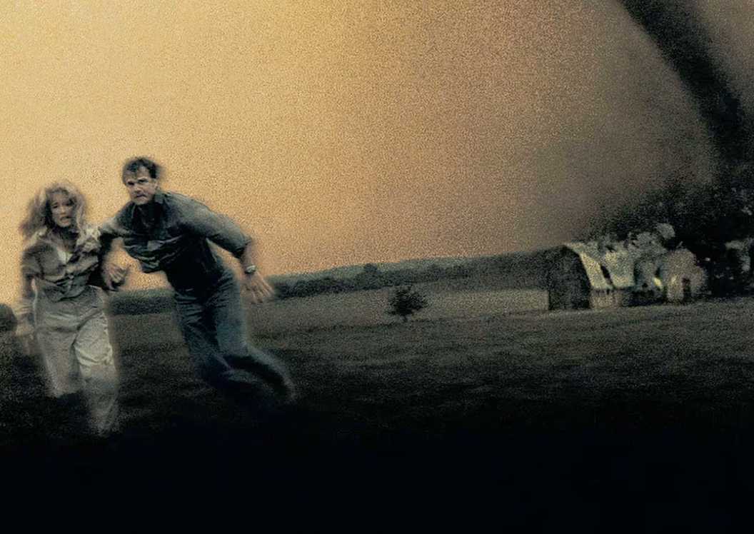 Bill Paxton and Helen Hunt run from tornados in Twister (1996)