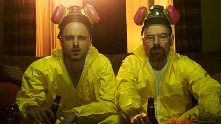 Breaking Bad still featuring Aaron Paul and Bryan Cranston in yellow hazmat suits and gas masks.