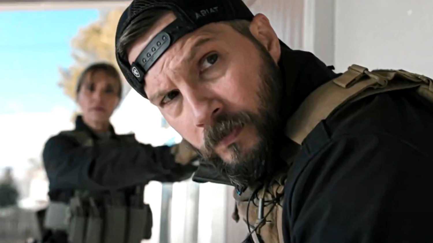 Cal looking confused towards something with Belle standing in the background in Marshals season 1