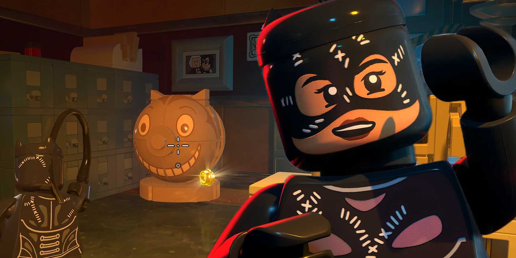 Catwoman with a cat head collectible in an edited screenshot from LEGO Batman Legacy of the Dark Knight.