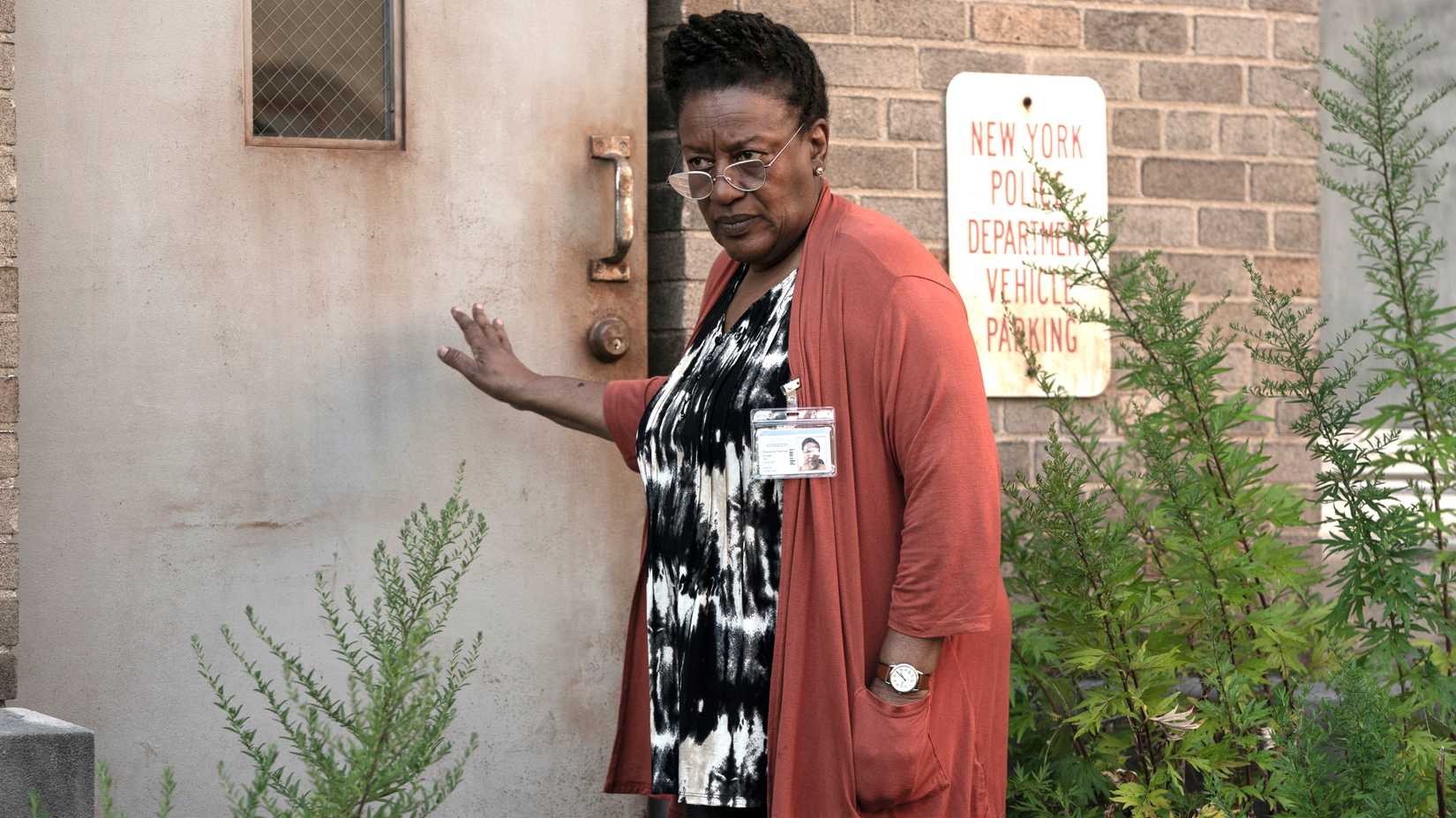 cch pounder s miss chris looking suspiciously while standing by a door in the terror the devil in silver