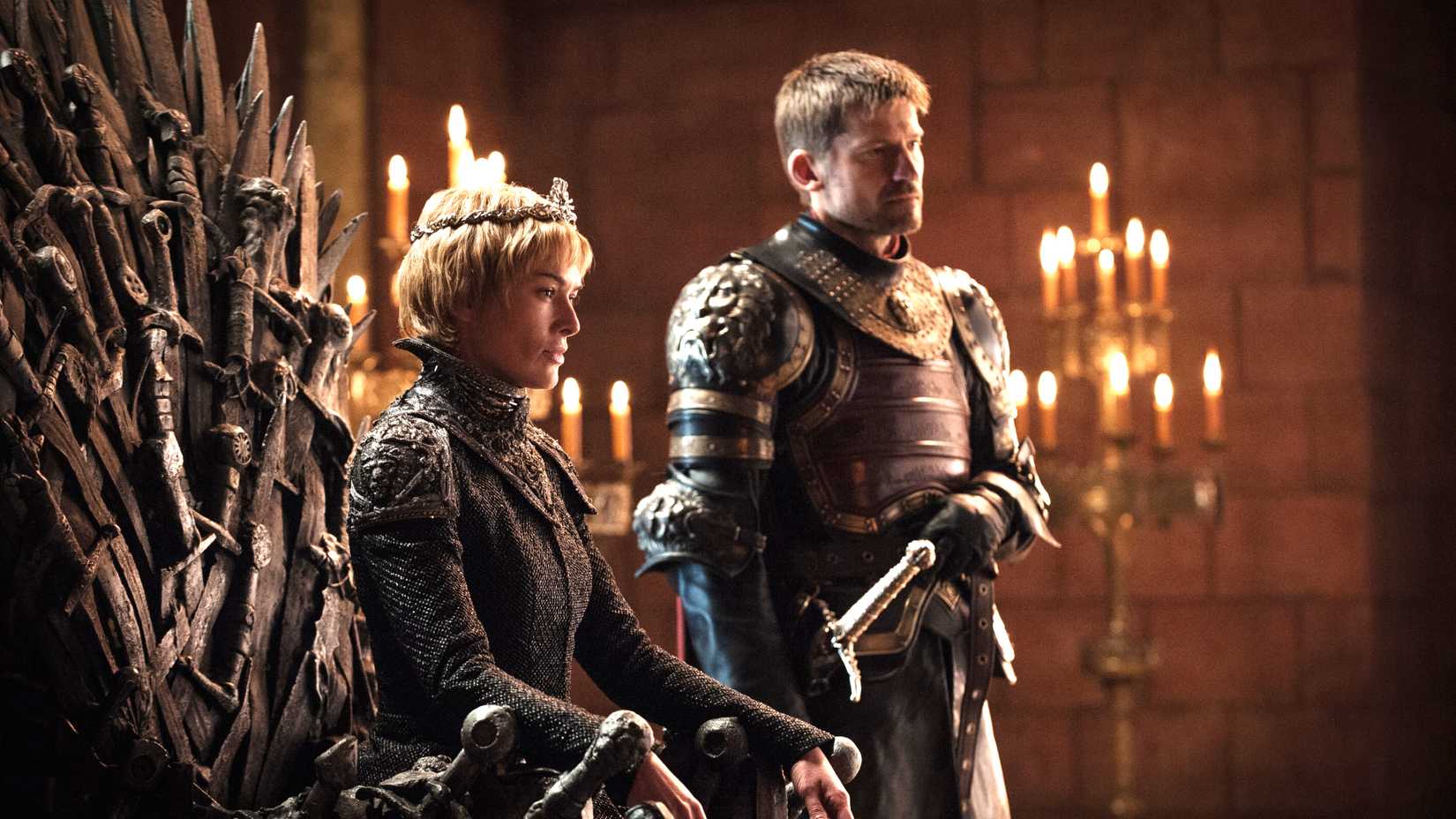 Cersei sitting on the iron throne with Jaime Lannister next to her in Game of Thrones