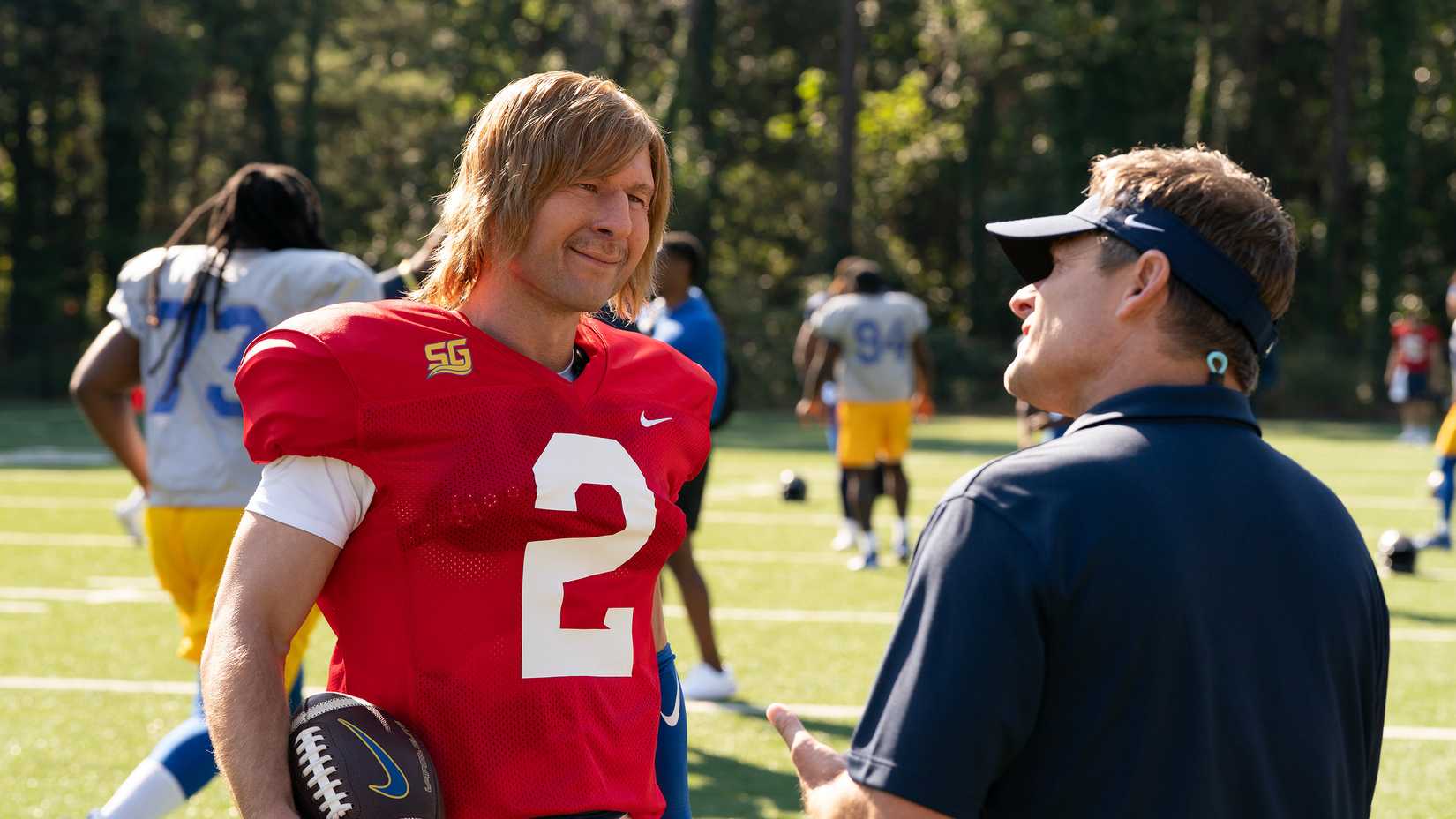 Chad talking to coach at practice in season 1.