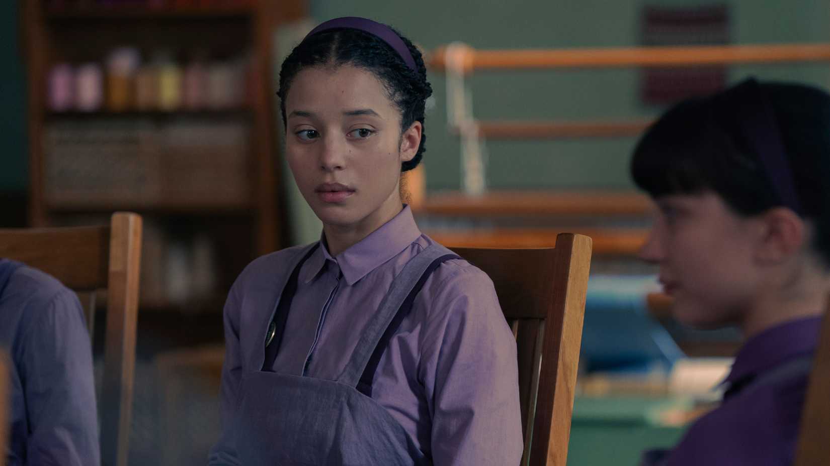 Chase Infiniti as Agnes looking off to the side in The Testaments